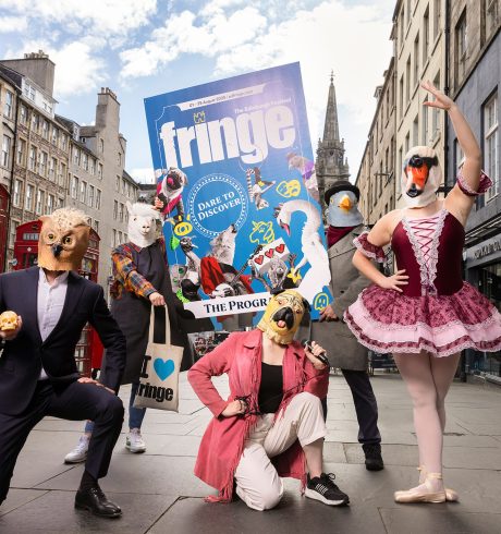 A photograph taken on the Royal Mile in Edinburgh of the Fringe Programme and various characters