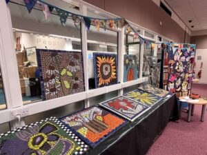 Mosaics, flags and a banner on display at Forfar Library.