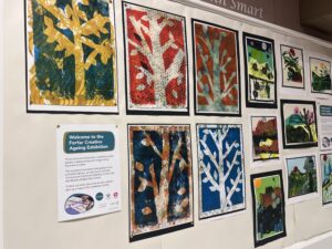 Display board showing prints and other artworks at Forfar Library