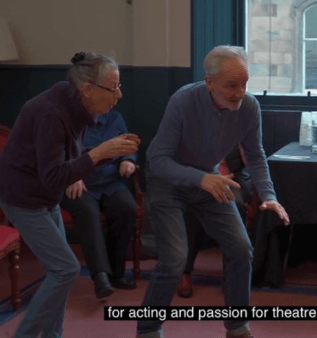 A woman and man performing at an acting class.