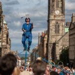 A man juggles while on a unicycle on Edinburgh's Royal Mile.