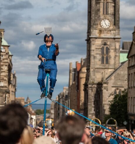 A man juggles while on a unicycle on Edinburgh's Royal Mile.