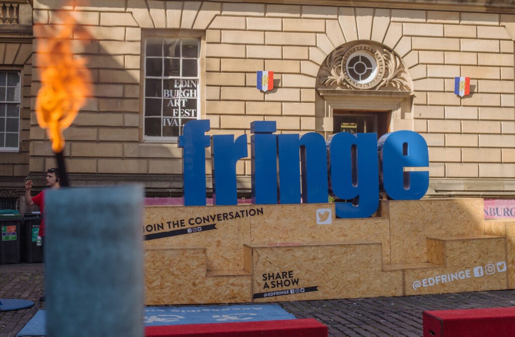 A large sign that says "Fringe" outside a building.